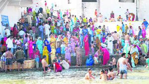 Pilgrims take a holy dip in the Tawi on Baisakhi in Jammu on Wednesday.