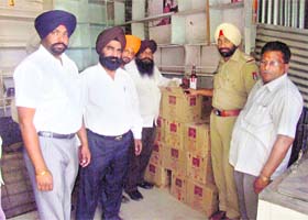 Police and excise officials with the liquor seized near Mullanpur Dakha