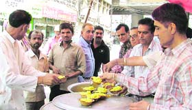 Rice being distributed among people on Baisakhi at the AC Market in Ludhiana