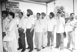 Customers at a bill payment centre even as PSEB staff went on strike in Mohali on Thursday