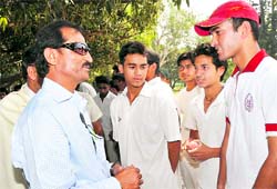 NK Sharma, SAI coach, talks to budding cricketers in Dehradun on Thursday.
