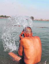 A pilgrim takes a bath at Brahmasarovar in Kurukshetra.