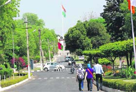 Students enter the Kurukshetra University campus as the Tricolour flutters in the background.