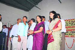 Finance Ministers wife Shakuntala Yadav distributes cheques among beneficiaries at a function in Rewari. 