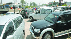 Supporters of candidates contesting the NRI Sabha elections disrupt vehicular traffic in front of a marriage palace on the GT Road in Jalandhar