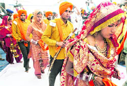 Couples at a mass marriage function held in Naushehra Dhalla, a border village, on Thursday.