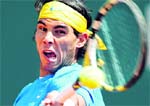 Rafael Nadal returns a shot to Michael Berrer during the Monte Carlo Masters in Monaco on Thursday. Nadal won 6-0, 6-1.  Reuters 