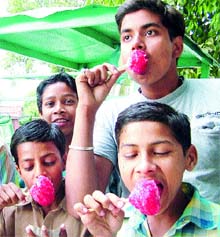 Schoolchildren enjoy ice candies in Amritsar. Photo: Vishal Kumar