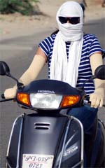 With mercury touching 44 degree Celsius mark in Bathinda, a girl on Friday rides with hands and face covered. A Tribune photograph