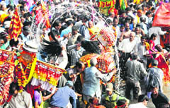A palanquin of a deity being dipped in the Ganga at the Har-ki-Pauri in Haridwar 