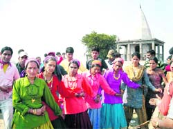    Villagers dance during Bissu mela celebrations at Devi Kol on Thursday.  