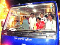 A police bus ferries pilgrims to ease rush at railway station in Haridwar. 