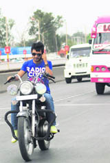 Unmindful of personal safety, this motorist is busy conversing on his mobile phone on a busy road in Jammu.
