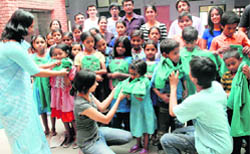 Slum children wear T-shirts donated by the Global Environment Concern at