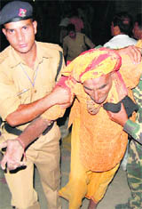 A pilgrim being rescued by police personnel at the Iyrish bridge in Haridwar on Friday night.