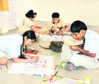 Students participate in an art competition at Doon Girls School in Dehradun on Saturday.