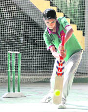 A batsman defends the ball during the Gardner Premier League in Dehradun on Saturday.