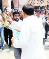 A UKD worker being bashed up by an employee of the Dehradun Municipal Corporation in Dehradun on Saturday.