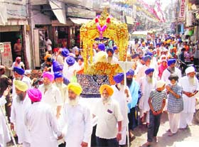 The Nagar Kirtan held to mark the 389th birth anniversary of Guru Teg Bahadur passes through the narrow lanes of Amritsar on Saturday.
