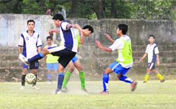 Players vie for the ball during a match of the RB Singh Memorial Football Tournament in Dehradun on Sunday. 