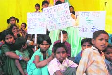 Children, who are deprived of education, hold a rally in support of the Right to Education Act in Dehradun on Saturday. 