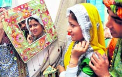 A student dressed in traditional Rajasthani attire takes a look at the Rajasthani wares on display during the Festival of Rajasthan in Ludhiana on Sunday. Tribune photo: Himanshu Mahajan