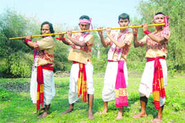 Musicians play a Bihu tune on their 10-foot-long flute that can be played by four men simultaneously in Sivasagar (Assam).