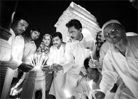 Activists of the Lok Janshakti Party participate in a candlelight vigil in front of India Gate in New Delhi in memory of 75 CRPF personnel killed in the recent Maoist attack in Chhattisgarh. 