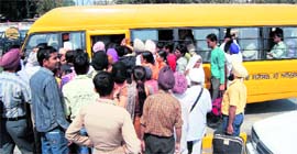 Devotees force their way into the free bus service being run by the SGPC to facilitate pilgrims to reach the Golden Temple from Amritsar railway station. Photo: Vishal Kumar