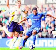 Chelseas Florent Malouda (R) vies with Michael Dawson (L) on Saturday.  AFP