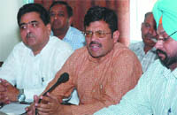 Senior BJP leader Kamal Sharma flanked by DP Chandan (left) and Manjit Singh Rai addressing a press conference in Bathinda