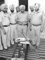Cops with the booty seized at Rajpura on Monday.