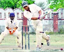 A batsman hits a shot on the onside in the Central Government Employees Welfare Coordination Committee Cricket Tournament held at Survey Grounds in Dehradun 