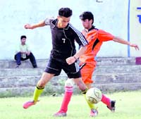A match of the 4th RB Singh Memorial Football being played in Dehradun on Monday. A Tribune photograph 