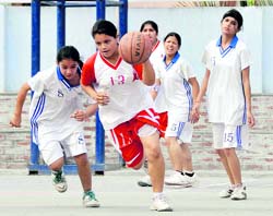 A girl of Hopetown School dribbles the ball in a match against DAV Public School in the District Junior (U-18 years) Basketball Championship (Boys and Girls) in Dehradun on Monday. A Tribune photograph