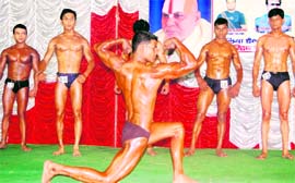Participants flex muscles at the Mr Haridwar Championship on Sunday