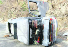 A tourist vehicle overturns on the Dehradun-Mussoorie road on Monday. 