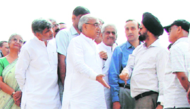 Chief Minister Bhupinder Singh Hooda inspects progress on the KMP expressway at Pachgaon village in Gurgaon district.