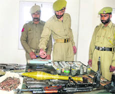 Arms and ammunition which were recovered by the security forces from a militant hideout in Baramulla district on Monday.