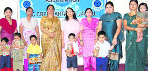 Children of CRPF personnal with members of the Regional CRPF Wives Welfare Association during a healthy baby show at Bantalab in Jammu on Monday.