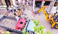 A demolition drive in progress at Janakpuri in Ludhiana on Monday. A Tribune photograph