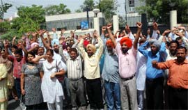 BSNL employees raise slogans in support of their demands, outside the BSNL office at Bharat Nagar in Bathinda, on Tuesday. Tribune photo: Pawan Sharma
