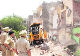 Officials of the Chandigarh Housing Board carry out an anti-encroachment drive in Sector 26-E