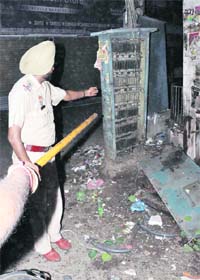 A policeman inspects the blast site at Patiala