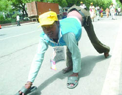 A disabled citizen participates in a protest march to Parliament, demanding 20 per cent quota in government jobs, rehabilitation, adequate health and educational facilities, in New Delhi on Tuesday.