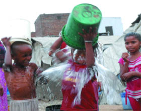 Children have fun taking bath on a hot day in Jalandhar. 
