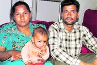 Raj Kaur and her husband with their third child. A Tribune photograph