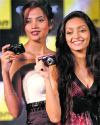 Models pose with Nikon cameras at a press conference in New Delhi on Wednesday. Nikon India launched eight new Coolpix cameras, priced between Rs 4,900 and Rs 24,950. Tribune photo: Mukesh Aggarwal