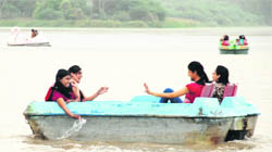 Girls enjoy boating on a cloudy Wednesday at Sukhna Lake.
