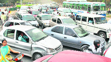 A scene of traffic jam due to the ongoing work of road carpeting at the roundabout of Sectors 29, 30, 31 and 32 in Chandigarh on Wednesday